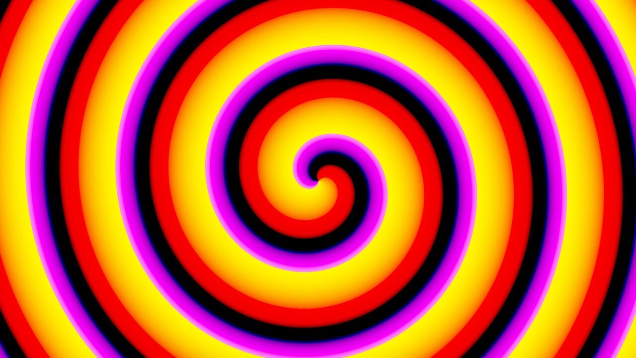 Bild på en färgglad spiral i gult, lila och rött.